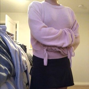 A cute pink sweater that can fit small or medium